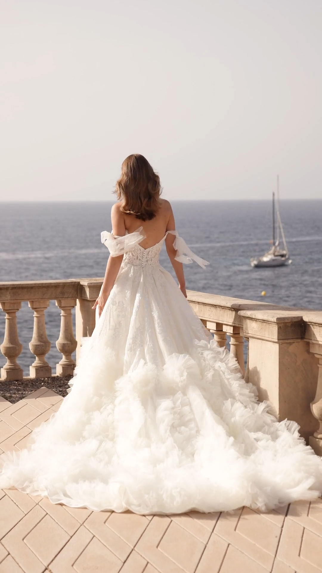 Lavish A-line ruffled hem wedding dress with leg slit and lace scoop bodice and detachable off the shoulder bow sleeves Lavish A-line ruffled hem wedding dress with leg slit and lace scoop bodice and detachable off the shoulder bow sleeves