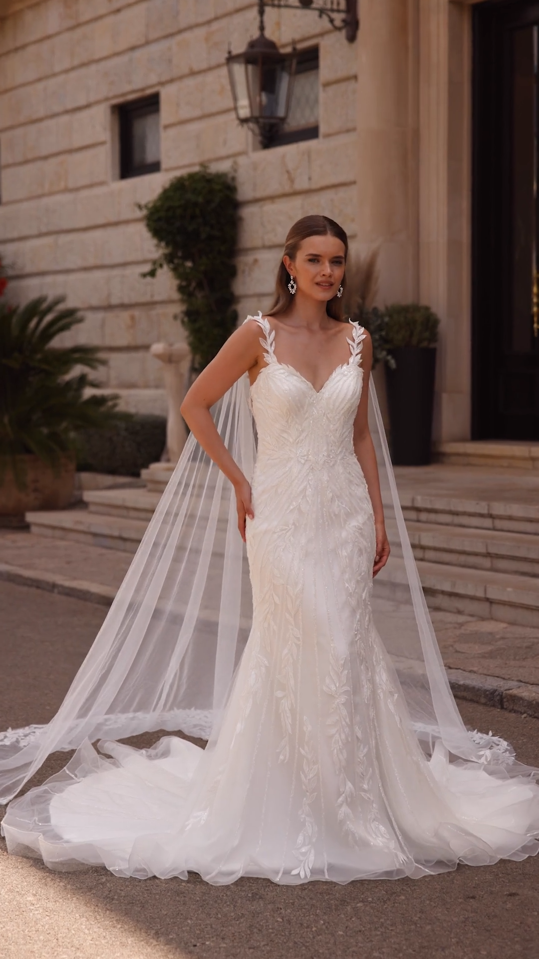 Beaded trumpet wedding dress with leaf leaf appliques and detachable tulle cape Beaded trumpet wedding dress with leaf leaf appliques and detachable tulle cape