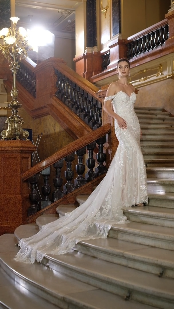 Val Stefani Bridal D8272 Beaded Floral Lace Strapless Mermaid Bridal Gown With Swag Sleeves And Long Sheer Shaped Sparkle Train