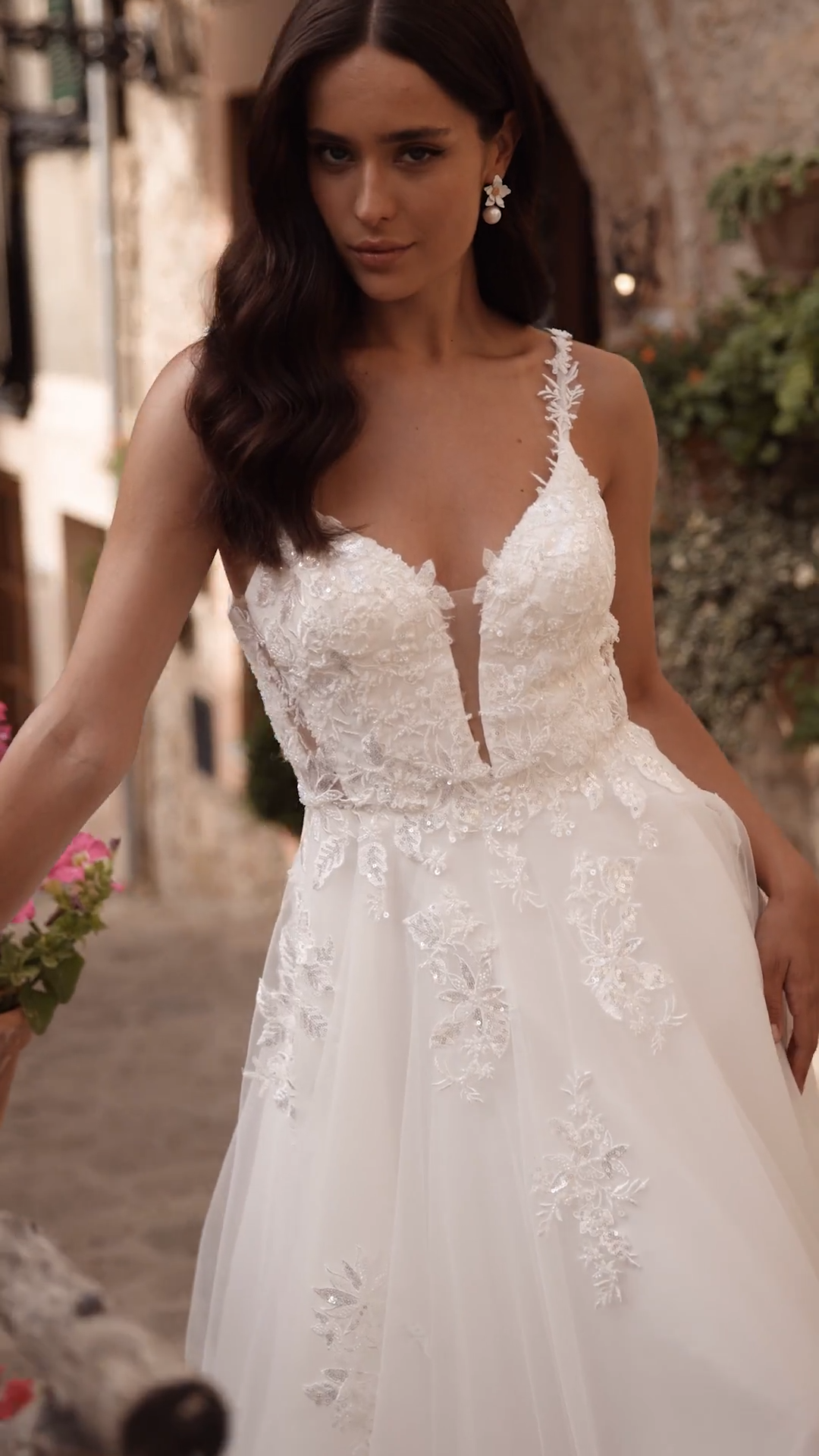 Bride wearing rustic tulle A-line wedding dress with side bodice cutouts and spaghetti straps Bride wearing rustic tulle A-line wedding dress with side bodice cutouts and spaghetti straps