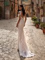 Back view of beaded bohemian wedding dress with deep low back and sweep train Back view of beaded bohemian wedding dress with deep low back and sweep train