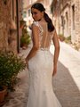 Close up of bride's illusion back wedding dress with buttons and loops along the back Close up of bride's illusion back wedding dress with buttons and loops along the back