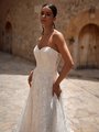 Closeup of bride wearing strapless sweetheart wedding dress with small floral lace Closeup of bride wearing strapless sweetheart wedding dress with small floral lace